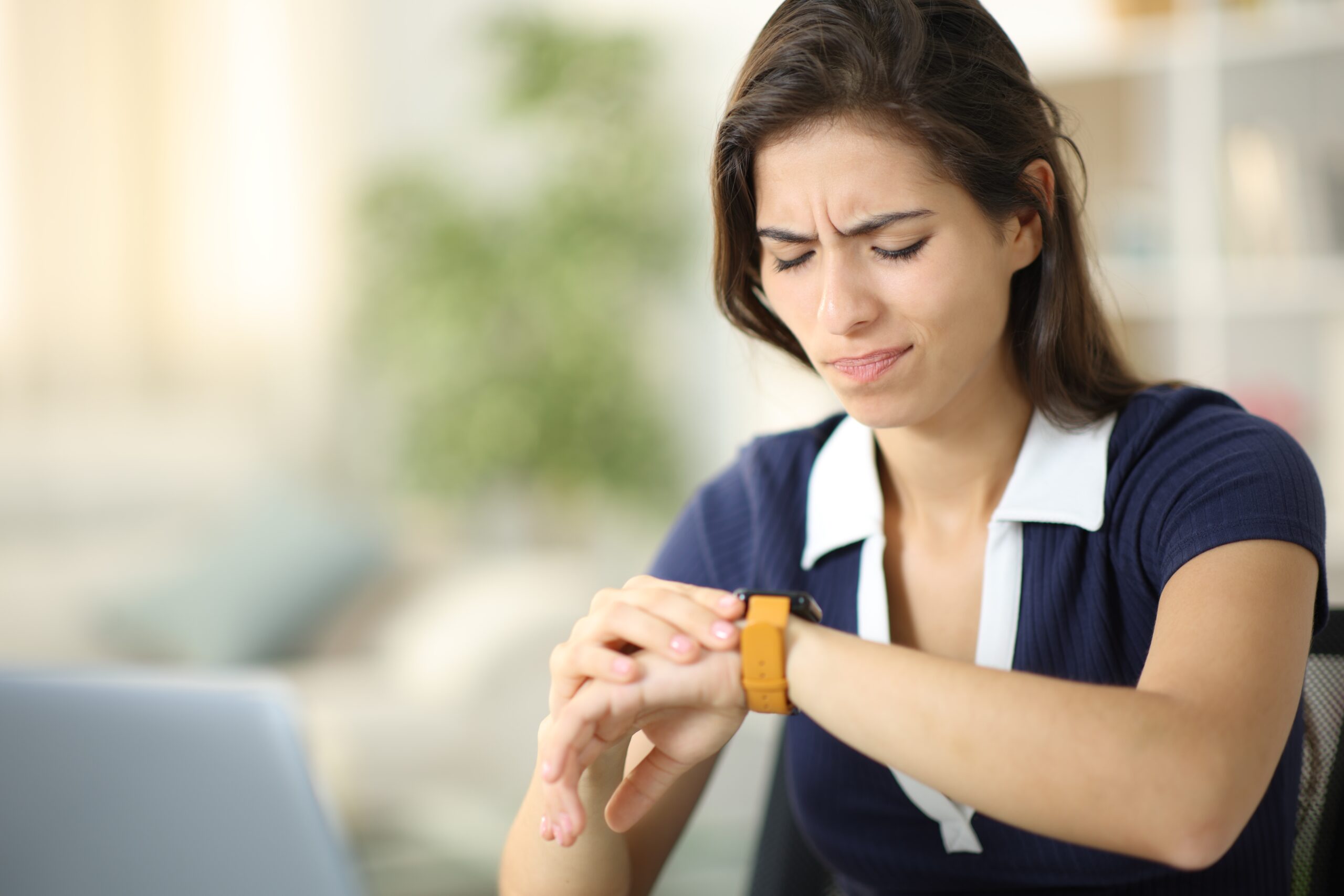 Frustrated woman checking watch